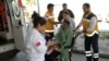 Medics take care of a rescued migrant at a local hospital in the Aegean resort of Didim, Turkey, March 6, 2016. Turkey's state-run news agency says 18 migrants have drowned off the Turkish coast while trying to reach Greece.