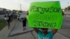 People march about a mile to the police station to protest the shooting of Michael Brown, Aug. 20, 2014, in Ferguson, Mo. 