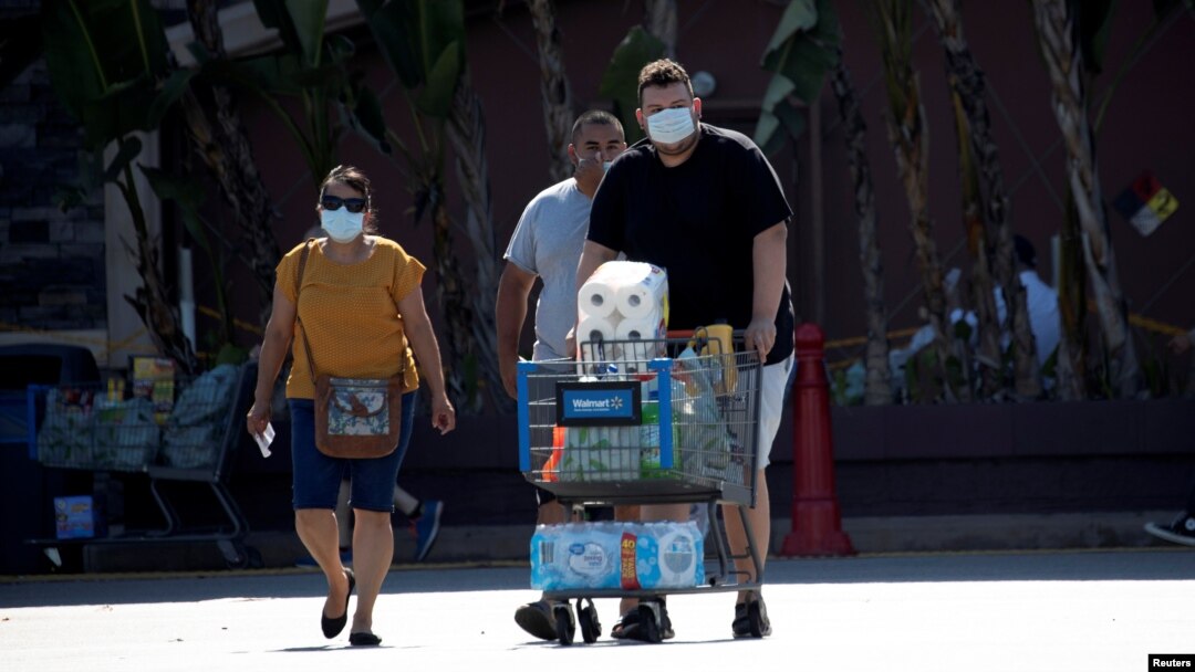 FILE - Shoppers wearing face masks are pictured outside a Walmart Superstore during the coronavirus pandemic, in Rosemead, California, June 11, 2020.