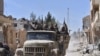 FILE - Syrian soldiers celebrate their victory against the Islamic State group in Qaryatain, Syria, April 4, 2016. 