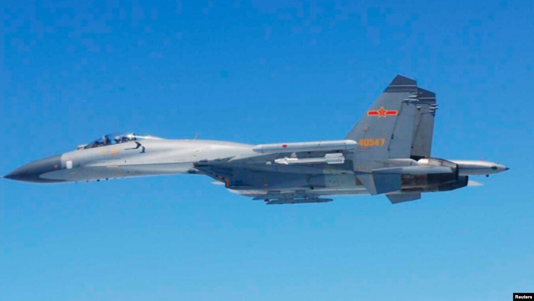 FILE - A Chinese SU-27 fighter flies over the East China Sea, in this handout photo taken May 24, 2014 and released by the Defense Ministry of Japan, May 25, 2014. 