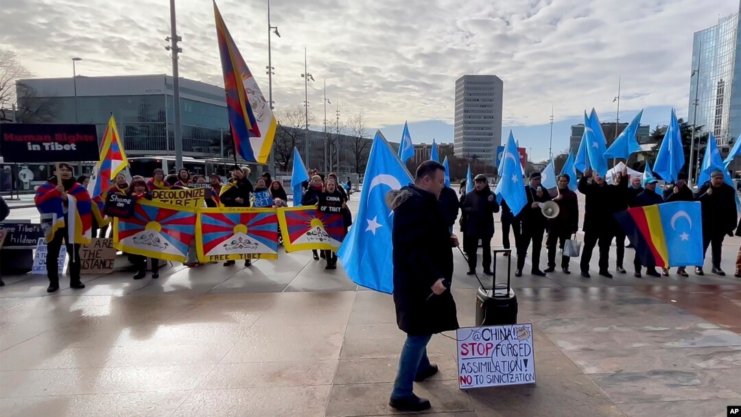 Activists supporting Tibet and the Uyghur minority in China protest against what they consider unfair Chinese government policies outside the U.N. office in Geneva, Switzerland on January 23, 2024. (AP Photo/Jamey Keaten)