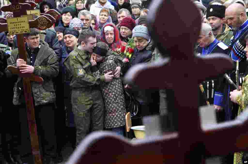 Family and friends of victims of the deadly attack on churchgoers in Russia&#39;s predominantly Muslim Dagestan region, attend a funeral service in Kizlyar, Russia.