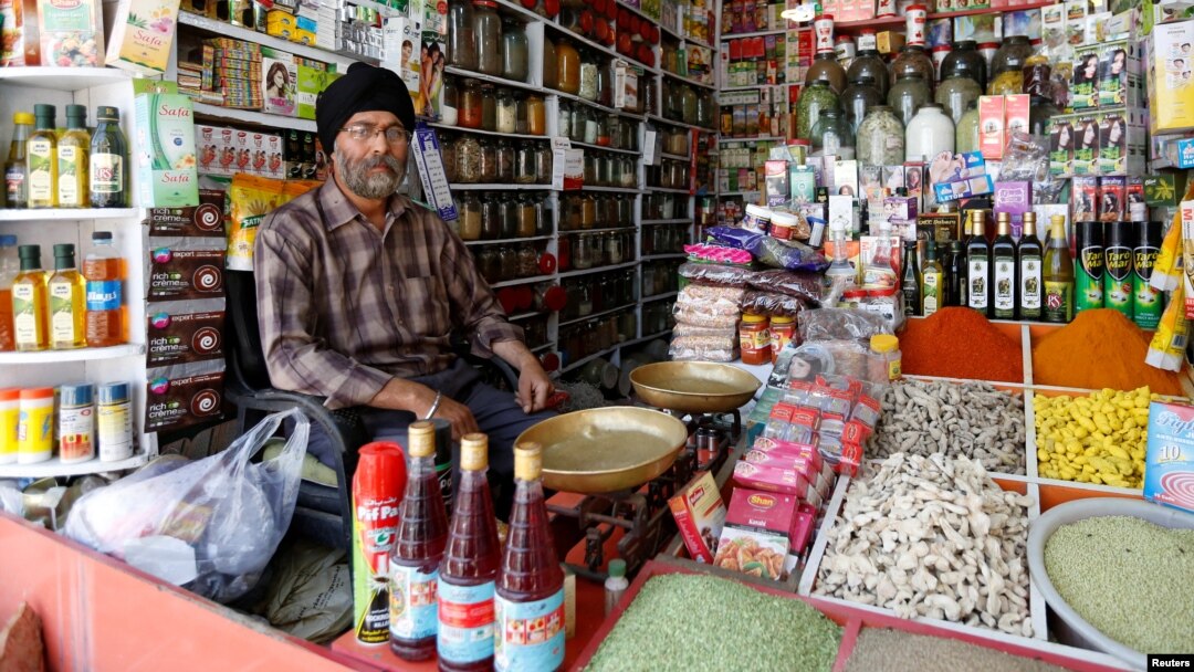 FILE - Afghan Sikh Jagtar Singh Laghmani, 50, sits at his traditional herb shop in Kabul, Afghanistan. 