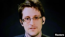 FILE - Edward Snowden delivers remarks via video link from Moscow to attendees at a discussion regarding an International Treaty on the Right to Privacy, Protection Against Improper Surveillance and Protection of Whistleblowers in Manhattan, New York, Sept. 24, 2015.