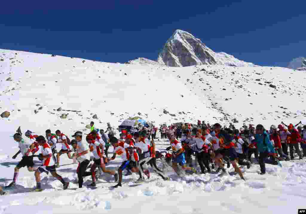 In this photograph received by Himex, the organizers of the Tenzing-Hillary Everest Marathon, participants run at the start of the race at Gorapshep near Mount Everest Base camp in Nepal.