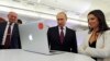 FILE - Russian President Vladimir Putin and Editor-in-chief of RT (Russia Today) 24-hour English-language TV news channel, Margarita Simonyan, attend an exhibition marking RT's 10th anniversary in Moscow, Russia.
