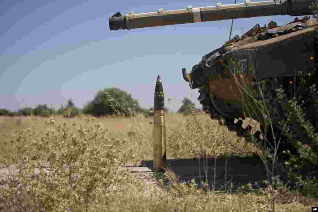 A shell is placed next to a tank near Alonei Habashan in the Israeli occupied Golan Heights, close to the cease-fire line between Israel and Syria, June 22, 2014.