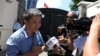 A Taiwanese citizen identified only as "William" speaks with the media outside the Taiwan embassy, Aug. 21, 2018.