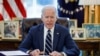 FILE - President Joe Biden signs the American Rescue Plan, a package of economic relief measures to respond to the impact of the coronavirus disease (COVID-19) pandemic, inside the Oval Office at the White House in Washington, March 11, 2021.