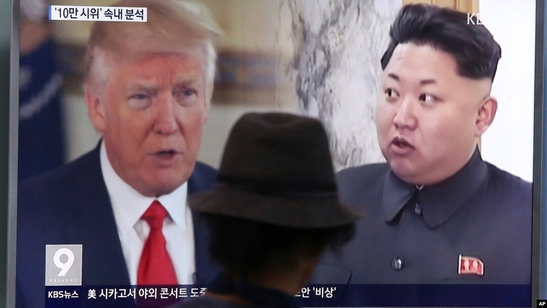 FILE - A man watches a TV screen showing U.S. President Donald Trump, left, and North Korean leader Kim Jong Un during a news program at the Seoul Train Station in Seoul, South Korea, Aug. 10, 2017. 