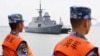 This photo taken on October 21, 2018 shows Chinese sailors watching as a Singapore navy ship arrives at a military port in Zhanjiang, in China's southern Guangdong province. 
