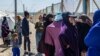 FILE - A group of women, reportedly the wives of suspected Islamic State (IS) fighters, are pictured on March 28, 2021 at Camp al-Roj,