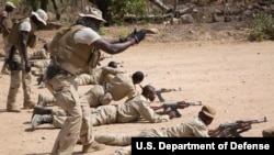 A Senagalese special forces soldier coaches a Burkinabe soldier during a marksmanship training event near Po, Burkina Faso, Feb. 23, 2019.