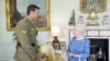 Britain's Queen Elizabeth II greets Corp. Ben Robert-Smith, from Australia, who was recently awarded the Victoria Cross, during an audience at Buckingham Palace in London, Nov.15, 2011. 