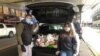 Chris Porr and his wife making food deliveries in Jackson Heights, Queens, New York. (Photo by New York Cares)