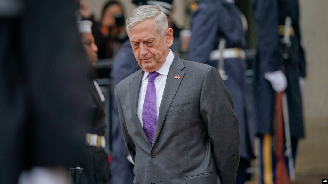 FILE - Defense Secretary Jim Mattis waits outside the Pentagon, Nov. 9, 2018. 