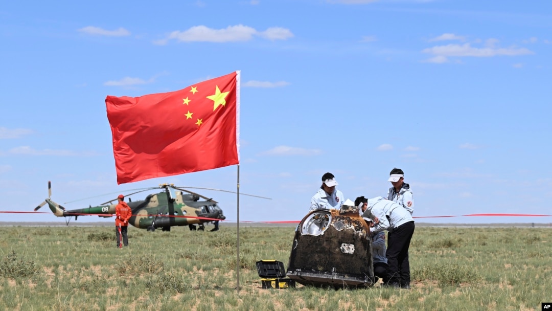 In this photo released by Xinhua News Agency, workers access the returned capsule of the Chang'e 6 probe in Siziwang Banner, northern China's Inner Mongolia Autonomous Region on June 25, 2024.