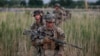 U.S. soldiers from 5-20 infantry Regiment attached to 82nd Airborne walk while on patrol in Zharay district in Kandahar province, southern Afghanistan, April 24, 2012.