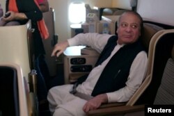 FILE - Ousted Pakistani Prime Minister Nawaz Sharif sits on a plane after landing at the Allama Iqbal International Airport in Lahore, Pakistan, July 13, 2018.