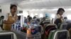 Female crew members serve lunch on board an Ethiopian Airlines flight from Addis Ababa Nairobi, April 27, 2013.