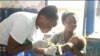 A nurse examines a baby in Idabato, Cameroon, Nov. 28, 2019. (Moki Edwin Kindzeka/VOA)