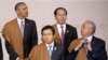 Malaysia's Prime Minister Najib Razak arranges his tie as he waits with U.S. President Barack Obama, top left, South Korea's Prime Minister Hwang Kyo-ahn, front left, and Vietnam's President Tran Dai Quang for the group photo at the annual Asia Pacific Economic Cooperation, APEC, summit in Lima, Peru, Nov. 20, 2016.