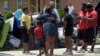 President Barack Obama greets residents as he tours Castle Place, a flood-damaged area of Baton Rouge, La., Aug. 23, 2016. 