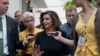 Speaker of the House Nancy Pelosi is surrounded by reporters as she arrives to meet with her caucus at the Capitol in Washington.