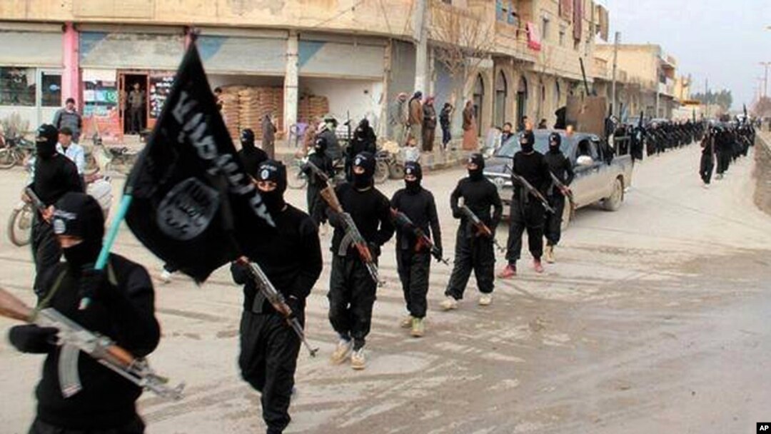 FILE - This undated file image posted on a militant website on Jan. 14, 2014, shows fighters from the al-Qaida linked Islamic State of Iraq and the Levant (ISIL) marching in Raqqa, Syria.