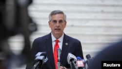 FILE - Georgia Secretary of State Brad Raffensperger gives an update on the state of the election and ballot count during a news conference at the State Capitol in Atlanta, Georgia, Nov. 6, 2020.