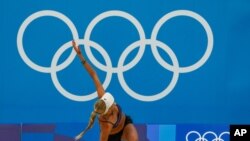 Germany's Margareta Kozuch stretches during a Beach Volleyball training session ahead of the 2020 Summer Olympics, July 20, 2021, in Tokyo.