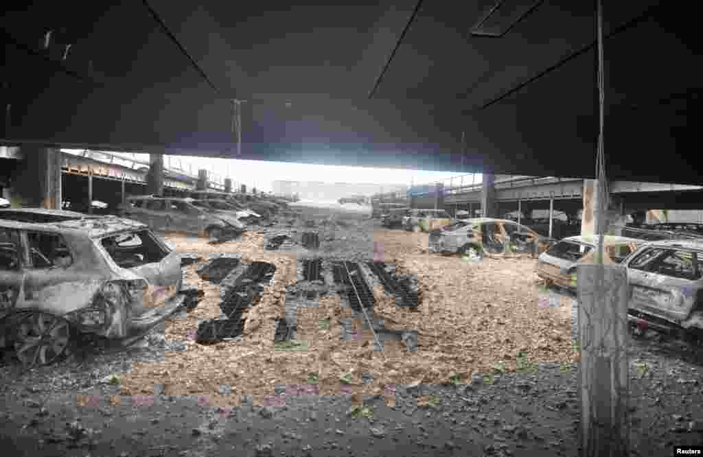 Burnt cars are seen in what remains of the multi-story car park, where a large fire destroyed many cars on Sunday, in King&#39;s Dock, Liverpool, Britain, Jan. 01, 2018.