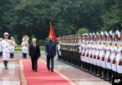 Indian President Ram Nath Kovind, right, and his Vietnamese counterpart Nguyen Phu Trong review an honor guard in Hanoi, Vietnam, Tuesday, Nov. 20, 2018.