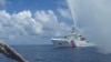 FILE - In this Sept.23, 2015 photo provided by Renato Etac, Chinese Coast Guard members approach Filipino fishermen as they confront them off Scarborough Shoal at South China Sea, in northwestern Philippines. (Renato Etac via AP)