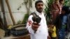 A Houthi Shiite rebel holds part of a projectile launched by Yemeni forces during clashes between Yemeni forces and Houthi militants in Sanaa, Yemen, Sept. 19, 2014. 