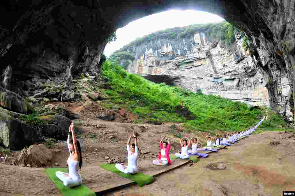 Yoga enthusiasts practice yoga at Yueyan Cave in Daoxian, Hunan province, China, Sept. 11, 2016.