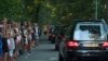 People pay their respects as a convoy of hearses, bearing remains of the victims of the Malaysia Airlines Flight MH17 crash, drive past in Hilversum, Netherlands, July 23, 2014. 