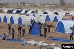 FILE - Workers prepare a tent camp in Khazer west of the Kurdish regional capital Erbil, Iraq, Oct. 11, 2016, for people expected to flee Mosul when the battles for Mosul begins.