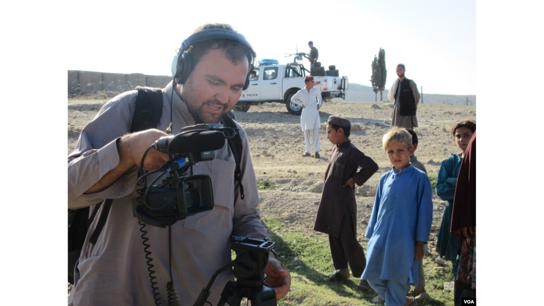 Boys observe as VOA cameraman Rahim Gul Sarwan prepares to shoot video in Achin district in eastern Afghanistan.