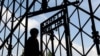 FILE - A visitor enters the Dachau Nazi concentration camp in Germany.