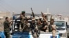 FILE - Houthi troops ride on the back of a police patrol truck in Sanaa, Yemen, Feb. 19, 2020. 