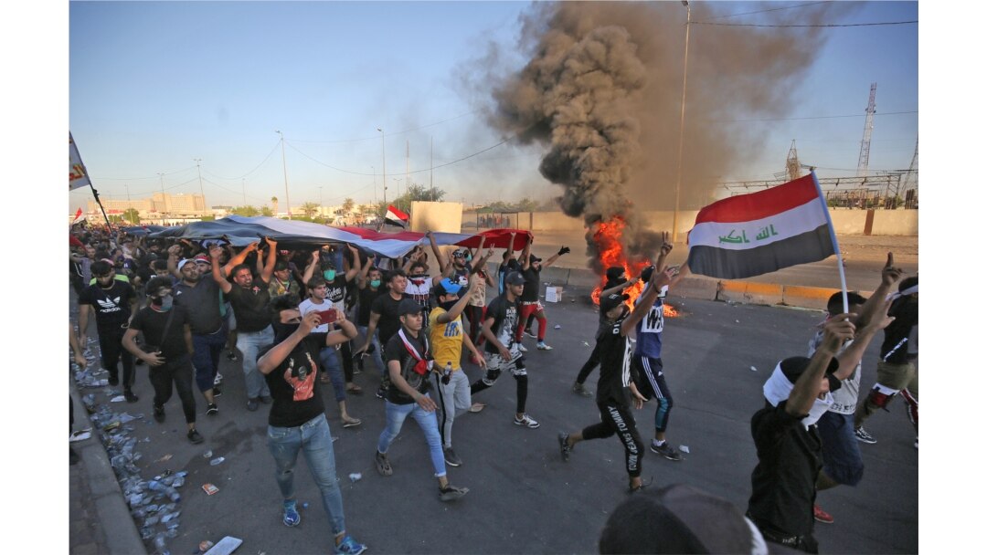 FILE - Iraqi protesters take part in a demonstration against state corruption, failing public services and unemployment, in Baghdad's central Khellani Square, Oct. 4, 2019.