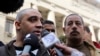 Adel, the brother of Canadian-Egyptian Mohamed Fahmy, one of the journalists working for Al Jazeera television, speaks to the media in front of a court in Cairo, January 1, 2015.