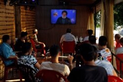 People listen to a speech by Hezbollah leader Sayyed Hassan Nasrallah being broadcast on Hezbollah's al-Manar TV channel, at a coffee shop in a southern suburb of Beirut, Lebanon, Aug. 25, 2019.