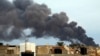 Smoke billows from a factory after an airstrike by forces loyal to former general Khalifa Haftar, in Benghazi, Libya, Oct. 22, 2014. 
