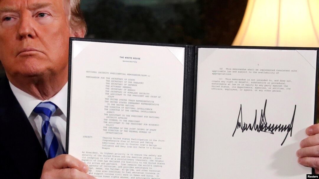U.S. President Donald Trump holds up a proclamation declaring his intention to withdraw from the JCPOA Iran nuclear agreement after signing it in the Diplomatic Room at the White House in Washington, May 8, 2018. 