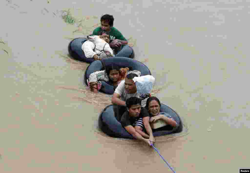 Flood victims are evacuated from heavy flooding brought by tropical depression "Agaton", in Butuan, in the southern Philippine island of Mindanao.