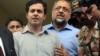 Awais Shah, center left, speaks to journalists with his father Sajjad Ali Shah, center right, chief justice of Sindh's High Court, after the son was rescued from kidnappers, in Karachi, Pakistan, Tuesday, July 19, 2016.