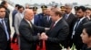 Pakistani Prime Minister Nawaz Sharif, center right, greets Afghan President Ashraf Ghani, upon his arrival at Nur Khan airbase in Rawalpindi, Pakistan, Dec. 9, 2015. 